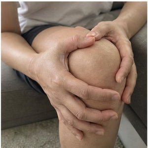 Hands on a sore knee