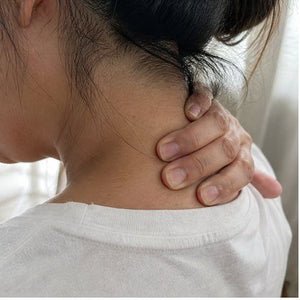 Hand on a tight neck and shoulder