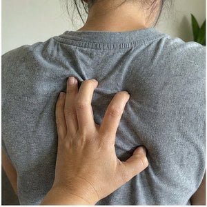 Hand on a tight upper back